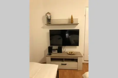 a living room with a tv and a table at Apartments Balkanska City Center in Belgrade
