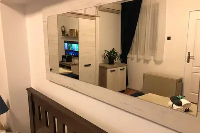 a mirror on the wall of a living room at Apartments Balkanska City Center in Belgrade