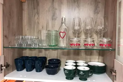 a shelf with glasses and a bottle on it at Apartments Balkanska City Center in Belgrade
