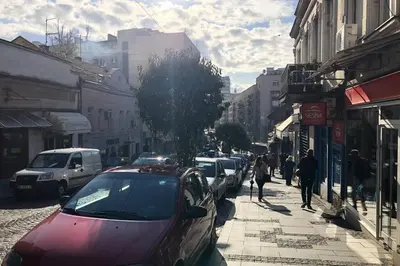 a street with cars parked on the side of the road at Apartments Balkanska City Center in Belgrade