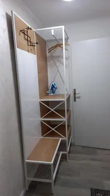a book shelf in a room with a closet at Apartments Balkanska City Center in Belgrade