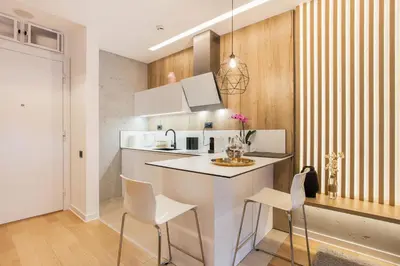 a kitchen with a white counter and white chairs at Leo Executive Suite, Self Check-In, Free Garage, FAST Wi-Fi, Concierge in Belgrade