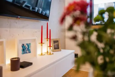 a fireplace with three candles on top of a mantle at Leo Executive Suite, Self Check-In, Free Garage, FAST Wi-Fi, Concierge in Belgrade