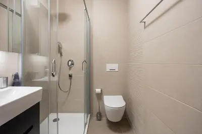 a bathroom with a shower and a toilet and a sink at Leo Executive Suite, Self Check-In, Free Garage, FAST Wi-Fi, Concierge in Belgrade