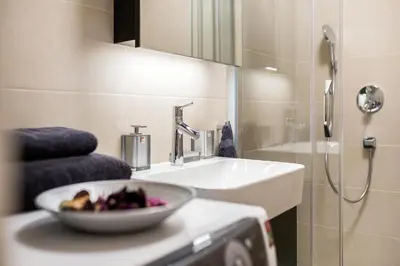 a bathroom with a sink and a bowl of fruit on a counter at Leo Executive Suite, Self Check-In, Free Garage, FAST Wi-Fi, Concierge in Belgrade