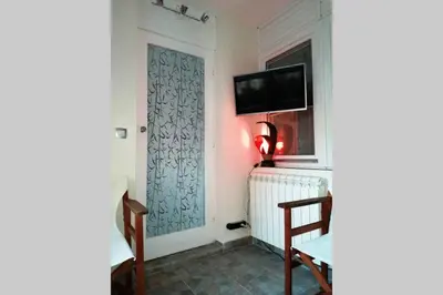 a room with a door and a tv on a wall at Oasis felix apartment in Belgrade