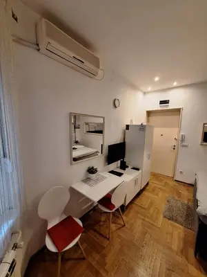 a room with a desk with a computer and a mirror at SQUARE M. in Belgrade
