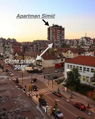 an aerial view of a city street with a tall building at Simic Apartman in Arandjelovac