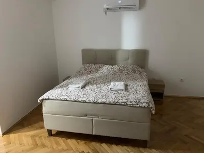 a bedroom with a bed with two towels on it at Simic Apartman in Arandjelovac