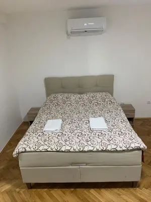 a bed with two trays on it in a bedroom at Simic Apartman in Arandjelovac