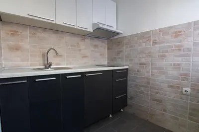 a kitchen with black cabinets and a sink at Filip in Belgrade