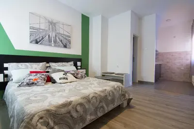 a bedroom with a large bed with pillows on it at Filip in Belgrade