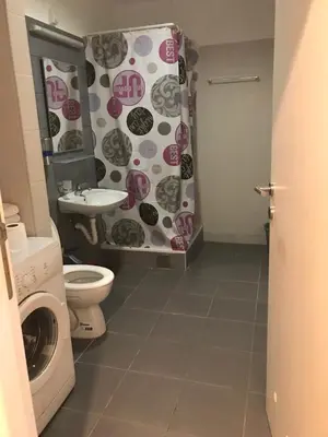 a bathroom with a washing machine and a shower curtain at STIV, Voždovac, Stepa Stepanovic in Voždovac