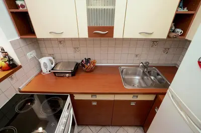 a small kitchen with a sink and a counter at Apartman Lido in Belgrade