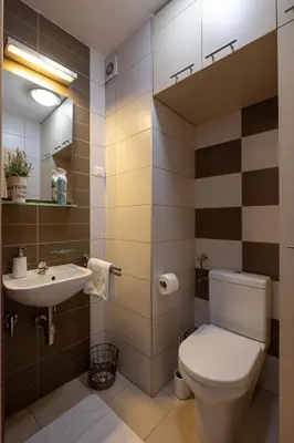 a bathroom with a toilet and a sink at La Maison Panoramique Belgrade in Belgrade