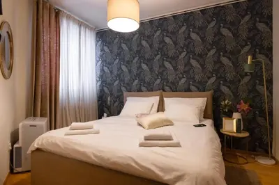 a bedroom with a large bed with towels on it at La Maison Panoramique Belgrade in Belgrade