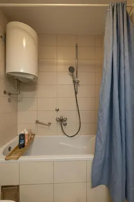 a bathroom with a bath tub with a shower at La Maison Panoramique Belgrade in Belgrade