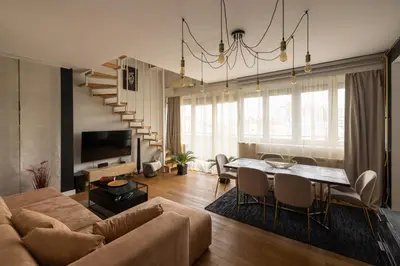 a living room with a couch and a table at La Maison Panoramique Belgrade in Belgrade