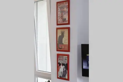 a wall with four pictures of a cat on it at ROCK - Studio with 30m2 terrace in Belgrade