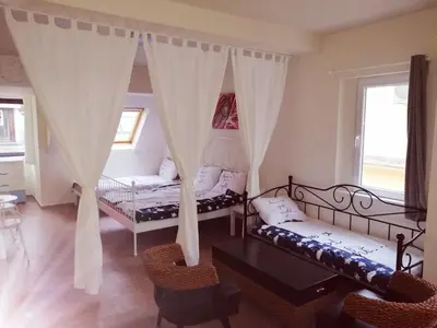 a living room with curtains and a couch and chairs at Retro apartment in Zemun