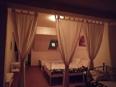a bedroom with a bed with curtains in it at Retro apartment in Zemun