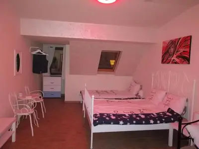 a bedroom with two beds and a table and chairs at Retro apartment in Zemun