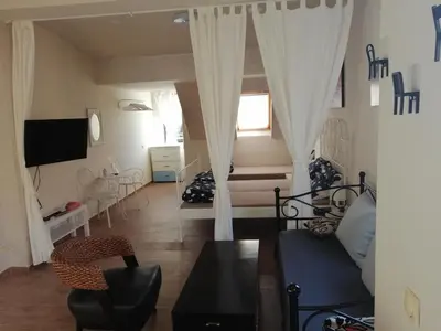 a living room with a couch and a tv at Retro apartment in Zemun