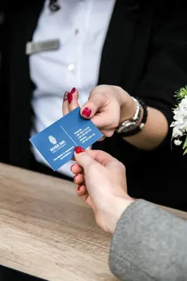 a woman holding a blue card in her hands at River Inn in Stari Banovci