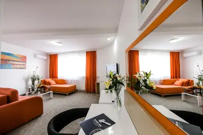 a living room with orange furniture and orange curtains at River Inn in Stari Banovci