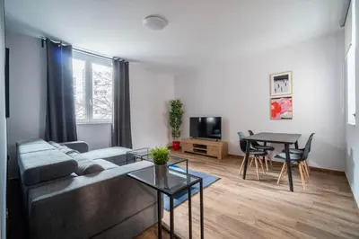 a living room with a couch and a table at HostGost Selected Suites - Botanical Garden in Belgrade