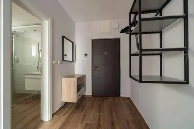 a room with a bathroom with a mirror and a shelf at HostGost Selected Suites - Botanical Garden in Belgrade