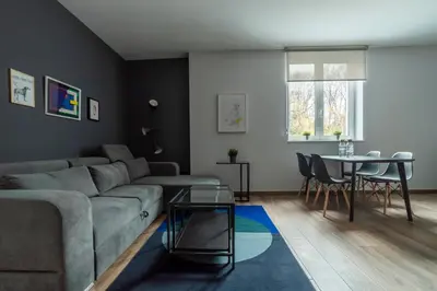 a living room with a couch and a table at HostGost Selected Suites - Botanical Garden in Belgrade