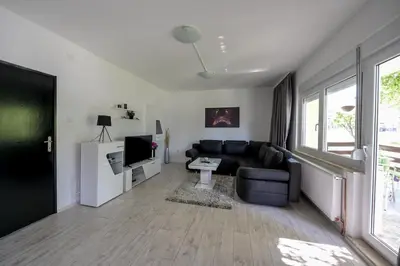 a living room with a couch and a tv at Apartman DORA in Arandjelovac