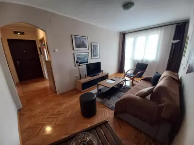 a living room with a couch and a television at Lagumska in Zemun