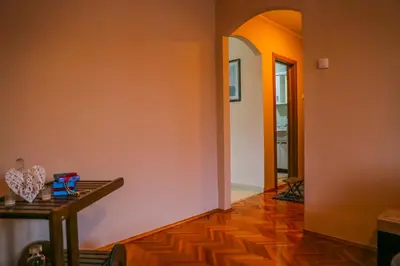 a hallway with orange walls and a wooden floor at Lagumska in Zemun