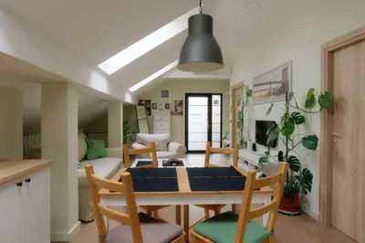 a kitchen and dining room with a table and chairs at VUKAJLO apartment Belgrade in Belgrade