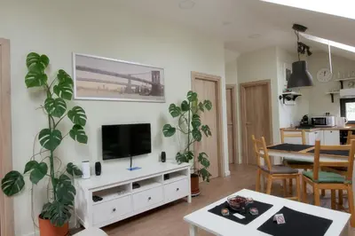 a living room with a television on a white cabinet at VUKAJLO apartment Belgrade in Belgrade