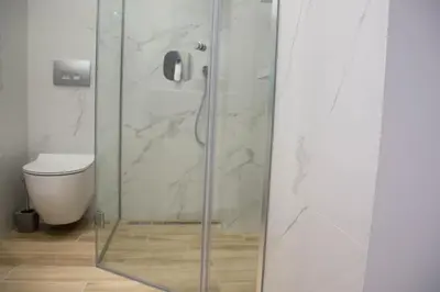a glass shower in a bathroom with a toilet at Etoile City Center Apartments- Obilicev venac in Belgrade