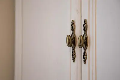 a white door with gold knobs on it at Etoile City Center Apartments- Obilicev venac in Belgrade