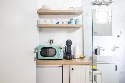 a microwave sitting on top of a counter in a kitchen at Etoile City Center Apartments- Obilicev venac in Belgrade