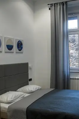 a bedroom with a large bed with a window at K43 Apartment in Belgrade