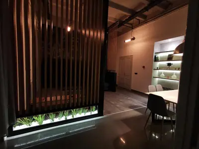 a room with a table and a window with a plant at K43 Apartment in Belgrade