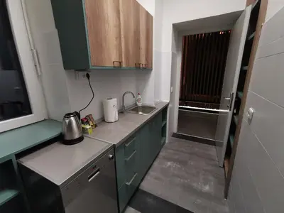 a small kitchen with green cabinets and a sink at K43 Apartment in Belgrade