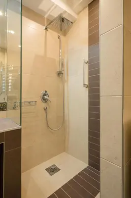 a bathroom with a shower with a glass door at BelArt apartment in Belgrade