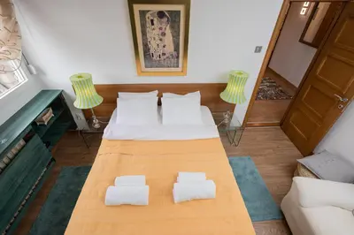 a room with two beds and two chairs at BelArt apartment in Belgrade