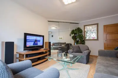 a living room with a flat screen tv and furniture at BelArt apartment in Belgrade