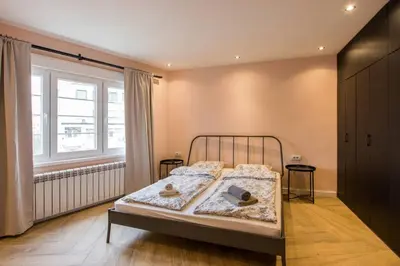 a bedroom with a bed and a window at Belgrade Old Town Apartment in Belgrade