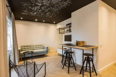 a living room with a couch and a table and chairs at Belgrade Old Town Apartment in Belgrade