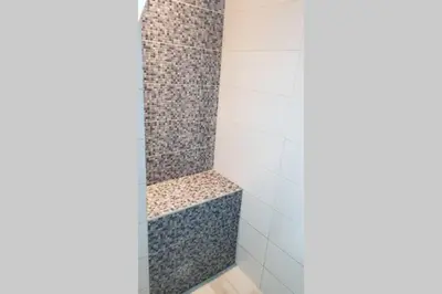 a bathroom with a shower with a shower seat at St. Marko studio in Belgrade