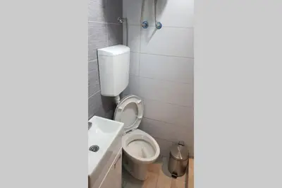 a bathroom with a toilet and a sink at St. Marko studio in Belgrade